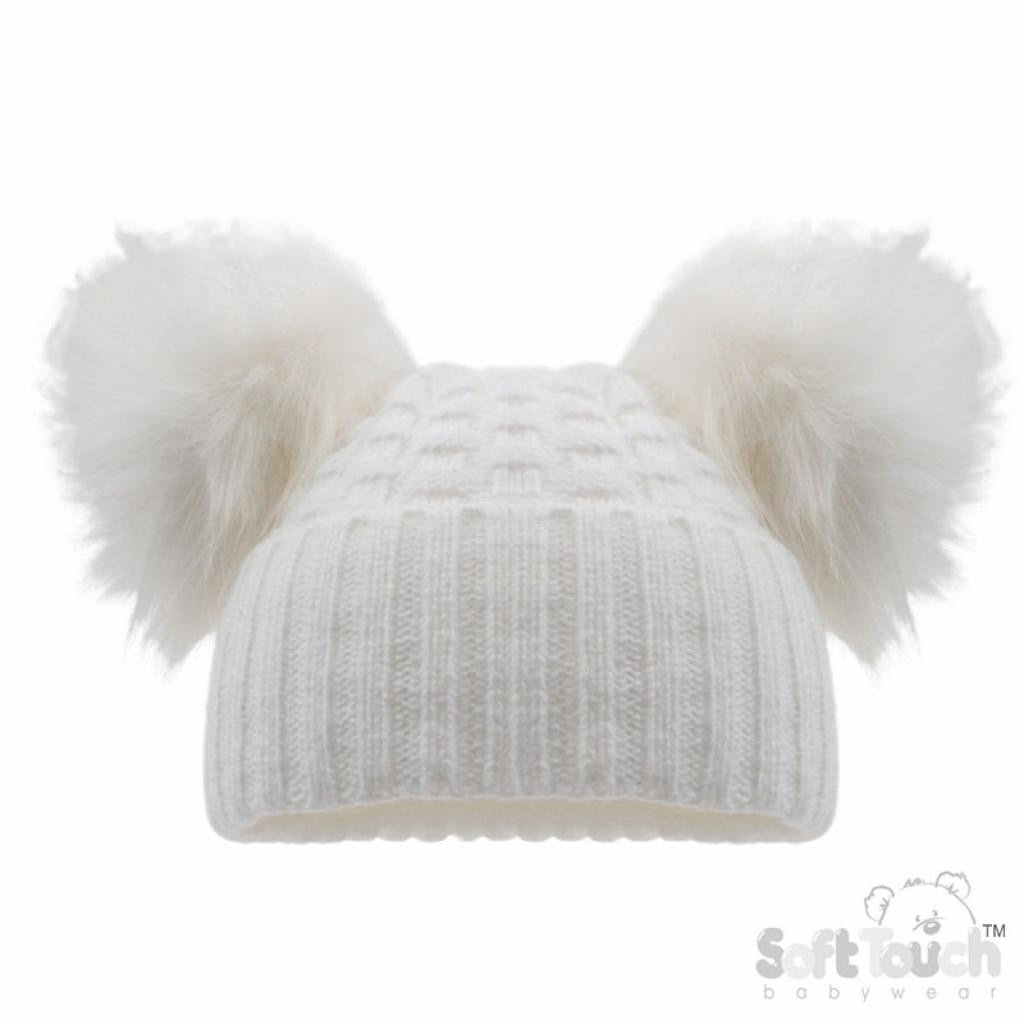 White knit beanie with two large white fur pom-poms on a white background