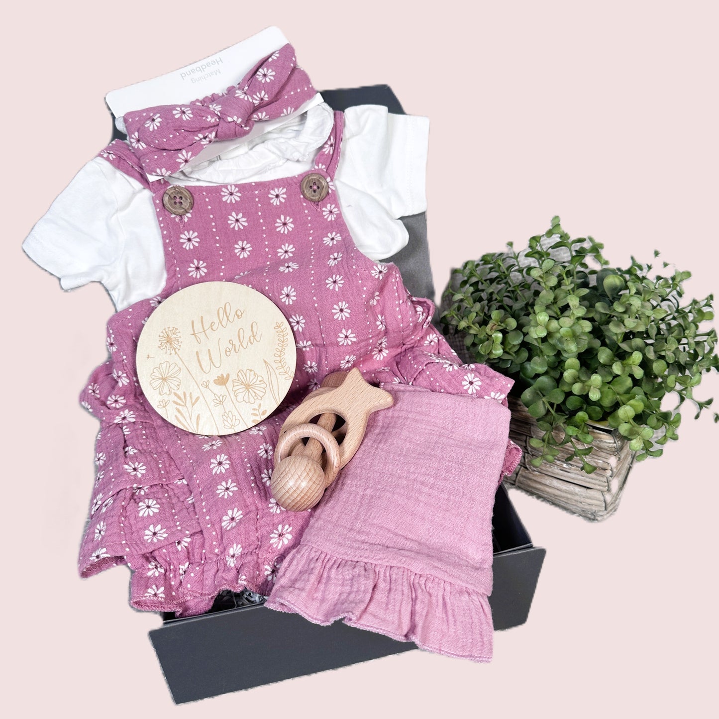 baby girl hamper with floral print baby romper, baby bib and baby teether.