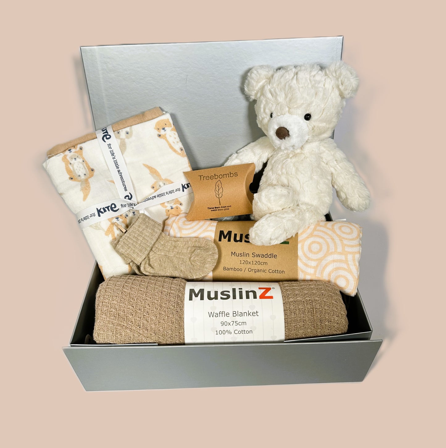 New baby girl hamper in a sliver coloured baby keepsake box which contains a Mary Meyer cream teddy bear, a muslins baby swaddle and baby blanket. 3 organic cotton baby muslins, one with an otter print.