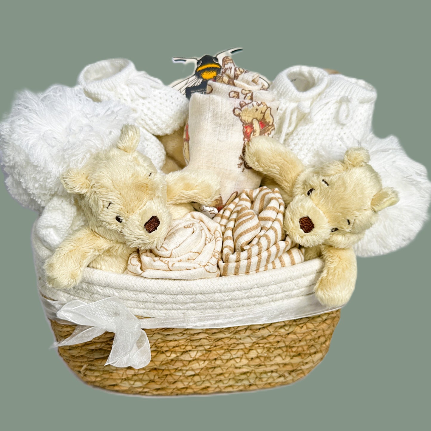 A baby hamper for twins with a Winnie-the-Pooh theme.