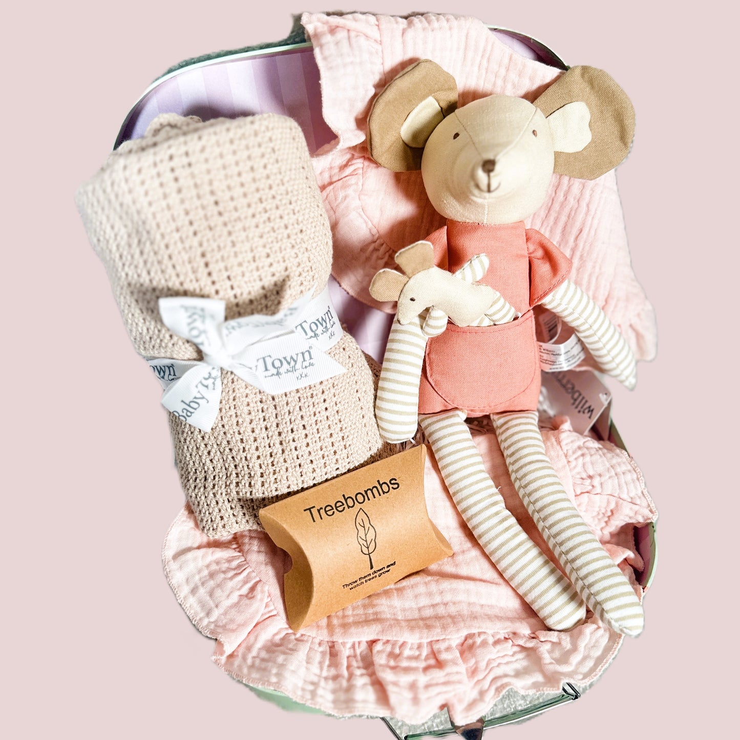 Baby girl hamper with taupe cotton baby blanket, pink baby bibs and a mouse soft baby toy