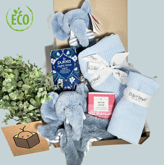 New Baby Boy Gift eco friendly contenys include a akeeleoc Ezra elephant comfoter and baby rattle, a blue cellular cotton baby blanket, a cotton muslin square, a bar of Choc Affair chocolate and a pack of "Night time "tea bags