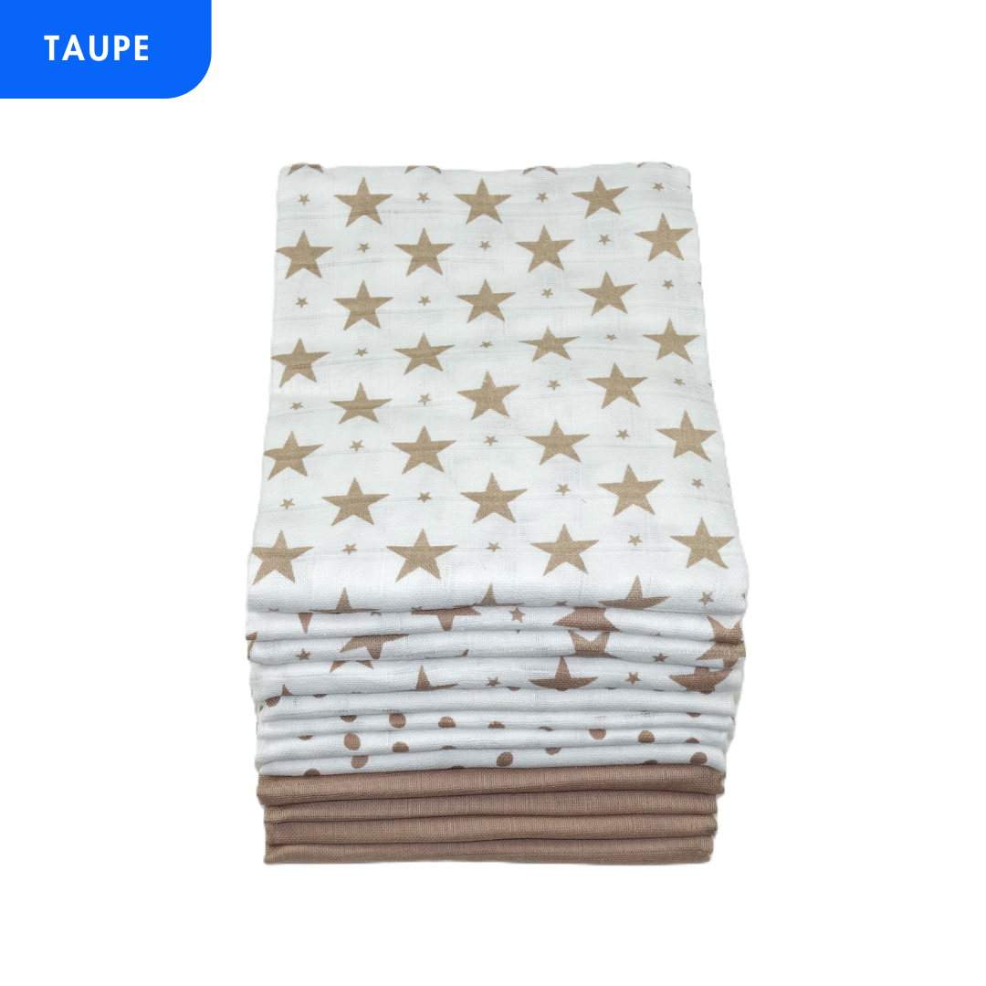 A stack of folded muslin baby blankets in taupe, featuring a white blanket with gold stars on top, a white blanket with gold polka dots, and a solid taupe blanket at the bottom. A blue 'TAUPE' label is in the top-left corner.