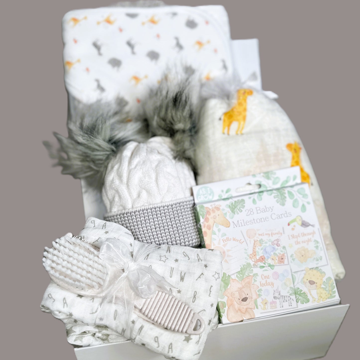 baby hamper with giraffe swaddle blanket and hooded baby towel.