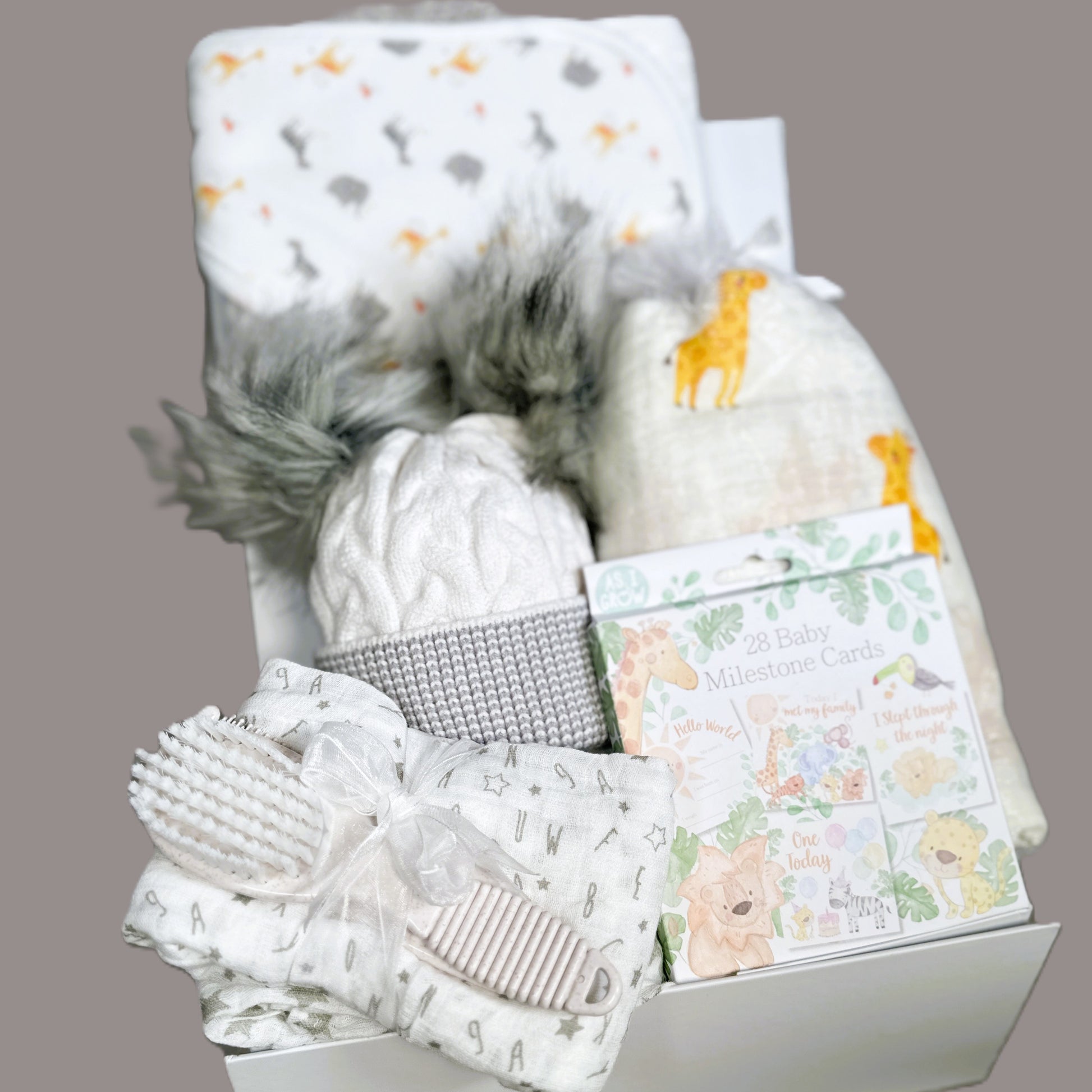baby hamper with giraffe swaddle blanket and hooded baby towel.