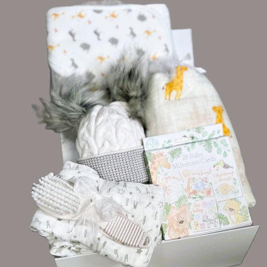 baby hamper with giraffe swaddle blanket and hooded baby towel.