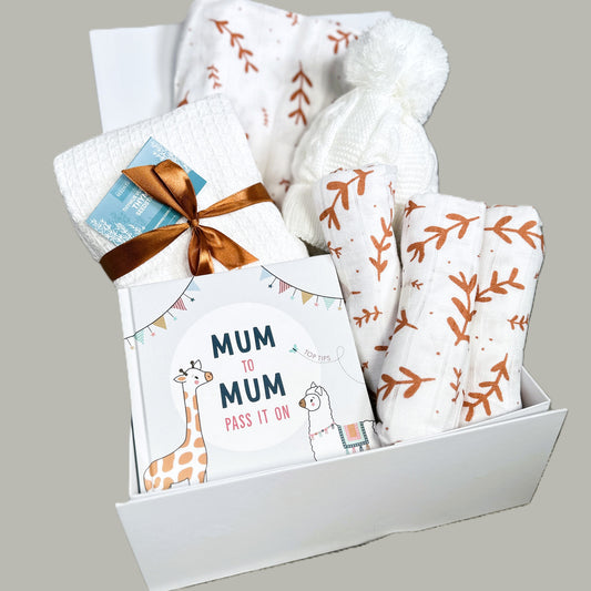 Baby hamper with muslins, swaddle blanket and book