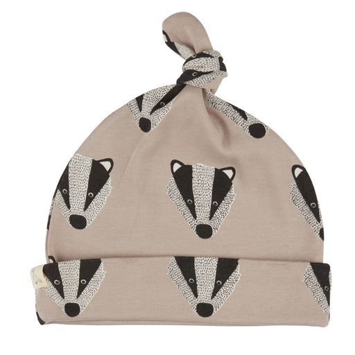 GOTS certified organic cotton baby knot hat in a stone colour with a black and grey badger face print. 
