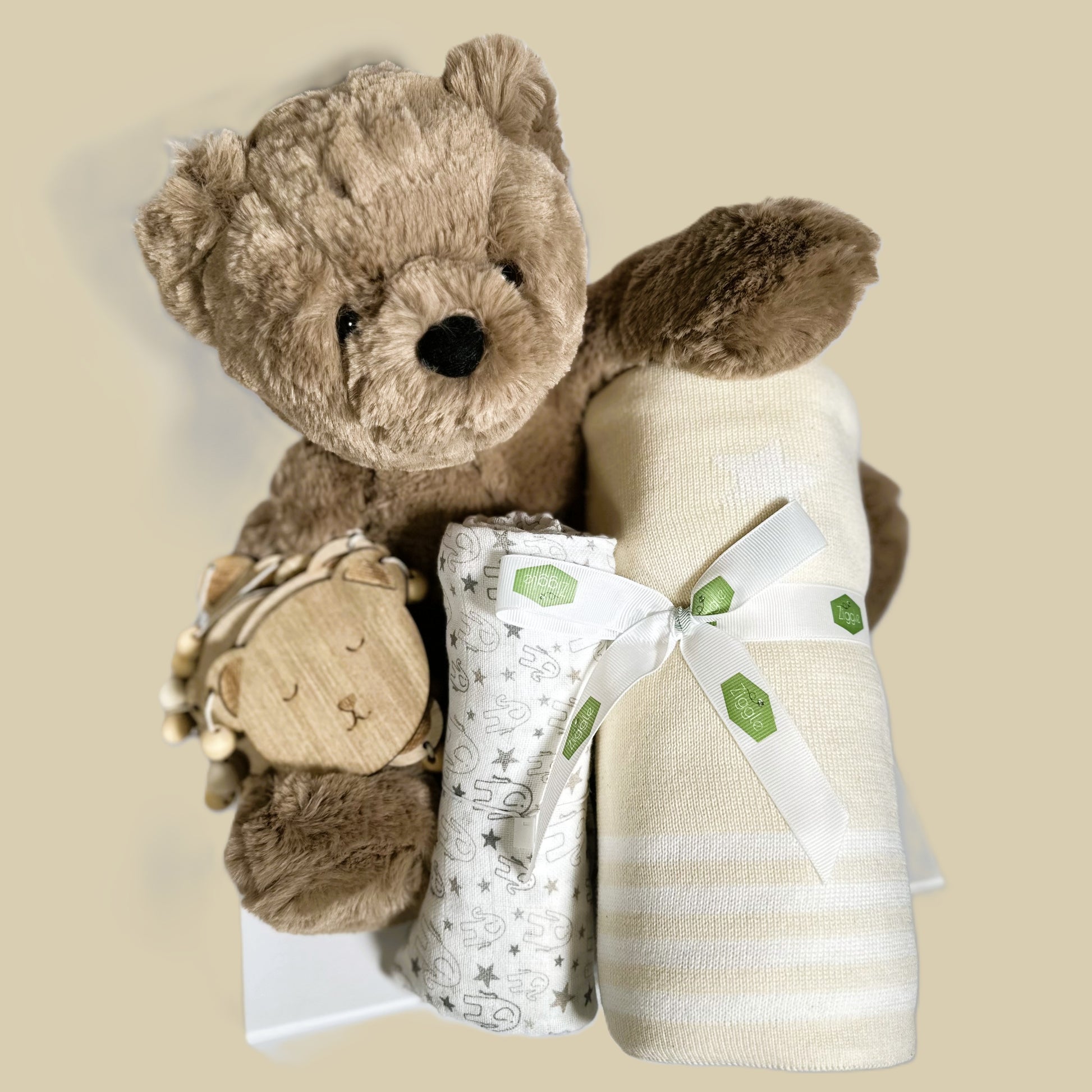 Avery bear baby hamper with teddy bear bunting, cotton baby blanket in cream, an elephant print muslin square and a white baby keepsake box.