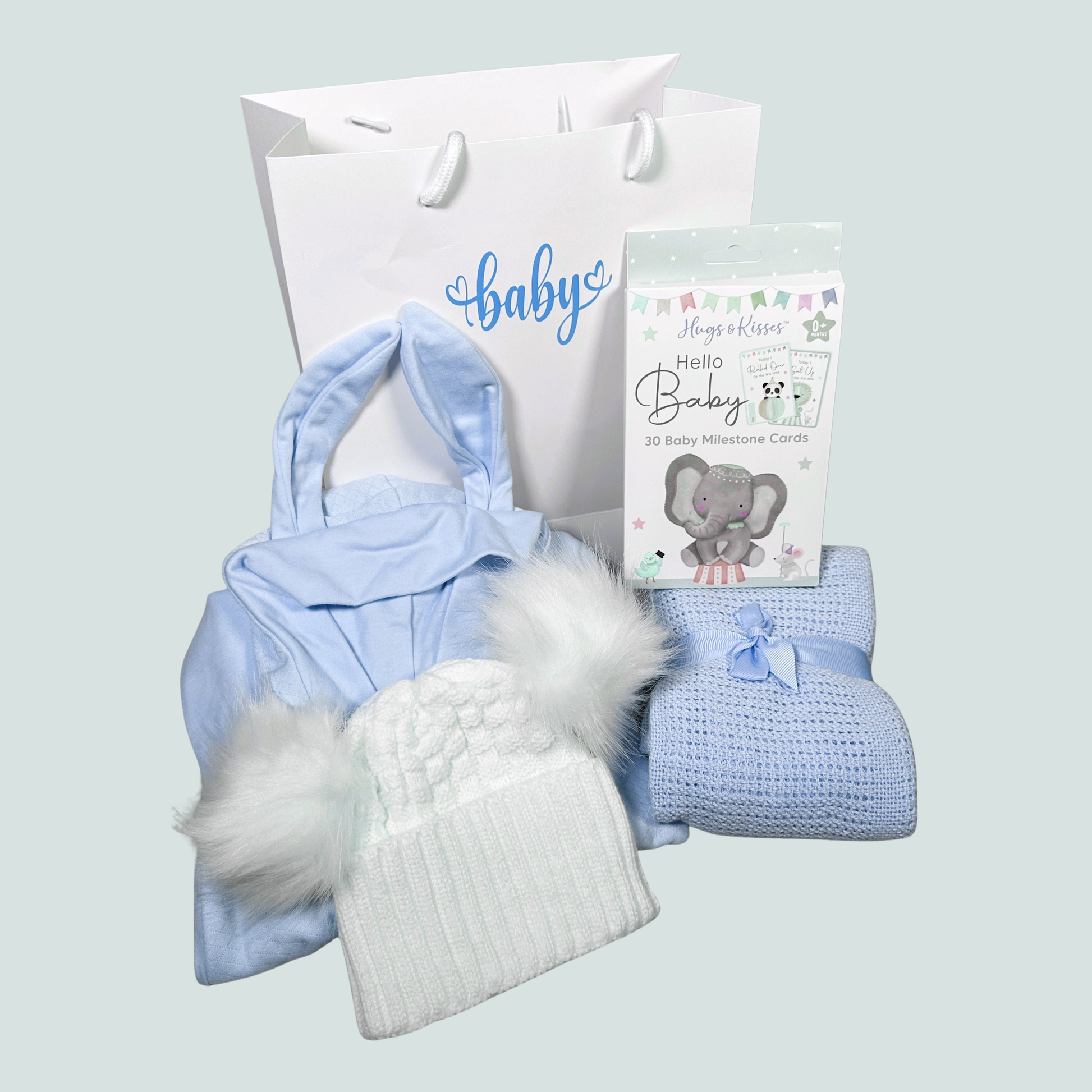 new baby boy gift hamper with a baby swaddle outfit,, a baby blanket, baby hat and gift bag.