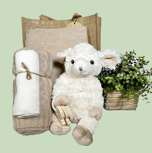New baby gift is a hessian "Mama" bag, a taupe cotton baby blanket, a hooded baby towel, a large muslin square, some wooded teething keys and a sweet lamb baby soft toy.
