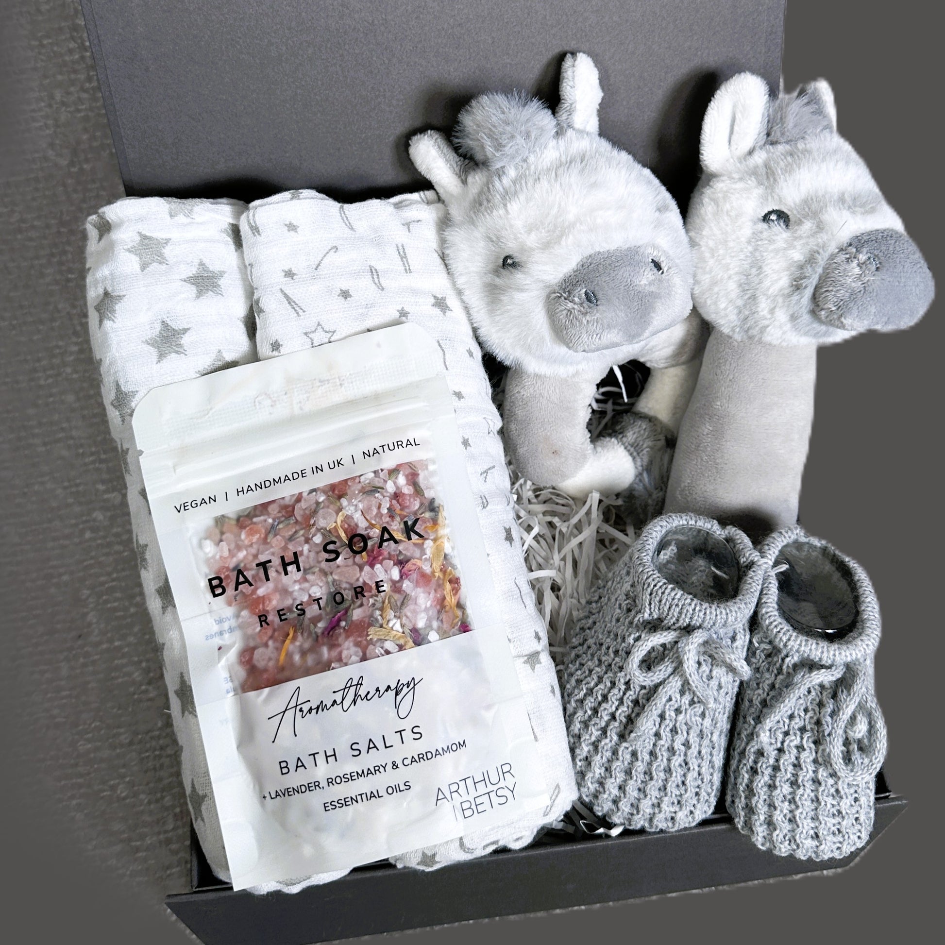 Baby gift set with, bath salts, and plush zebra baby rattles and muslins in a box.