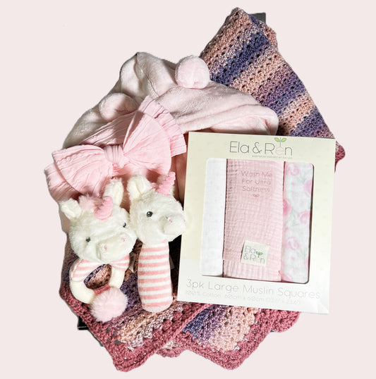 a lovely baby shower gift for girls this hamper comes in a grey baby keepsake box. It contains a crocheted baby blanket in pinks and purples, a pink hooded baby dressing gown, a set of pink and white baby muslin squares, a pink baby head band and two unicorn baby rattles.