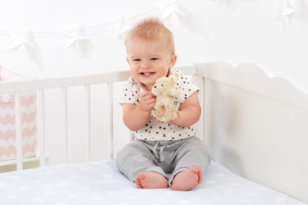 Baby with a Winnie the pooh baby rattle