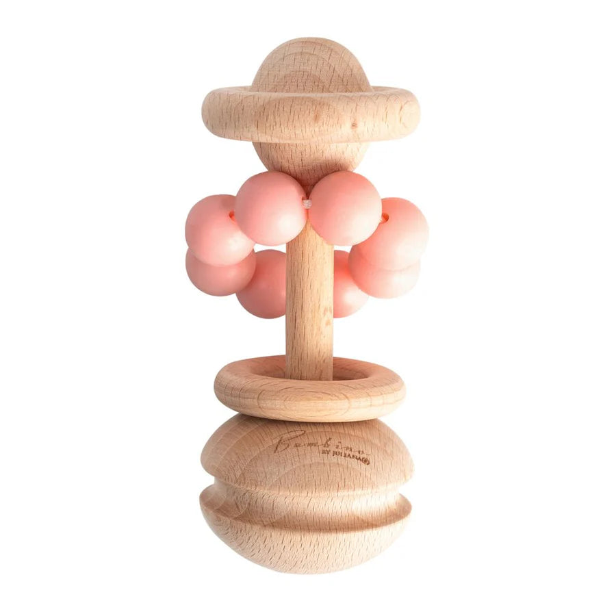 Wooden teething ring with pink silicone beads on a white background