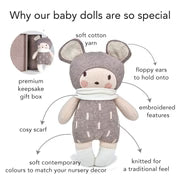 Baby doll with soft cotton body, premium knitted legs, and embroidered face, held by a hand.