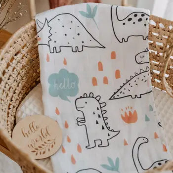  dinosaur print baby burp cloths in a wicker basket