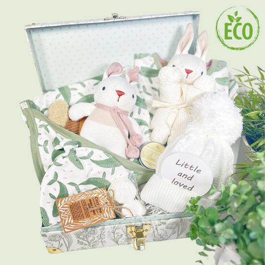 This new baby girl gift comes in a floral baby keepsake case which contains a GOTS certified organic baby blanket, baby body suit and matching baby knot hat, a baby pompom hat and Organic soft baby toys and natural toiletries for the new mummy.