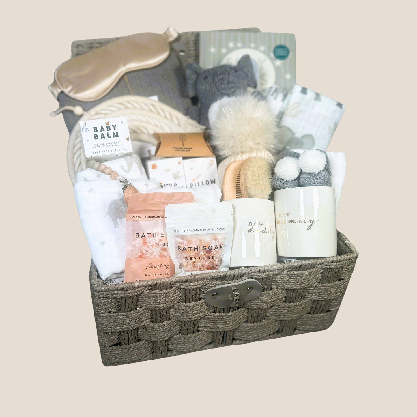 A new baby hamper filled with new baby essentials plus mummy and daddy mugs and baby toiletries