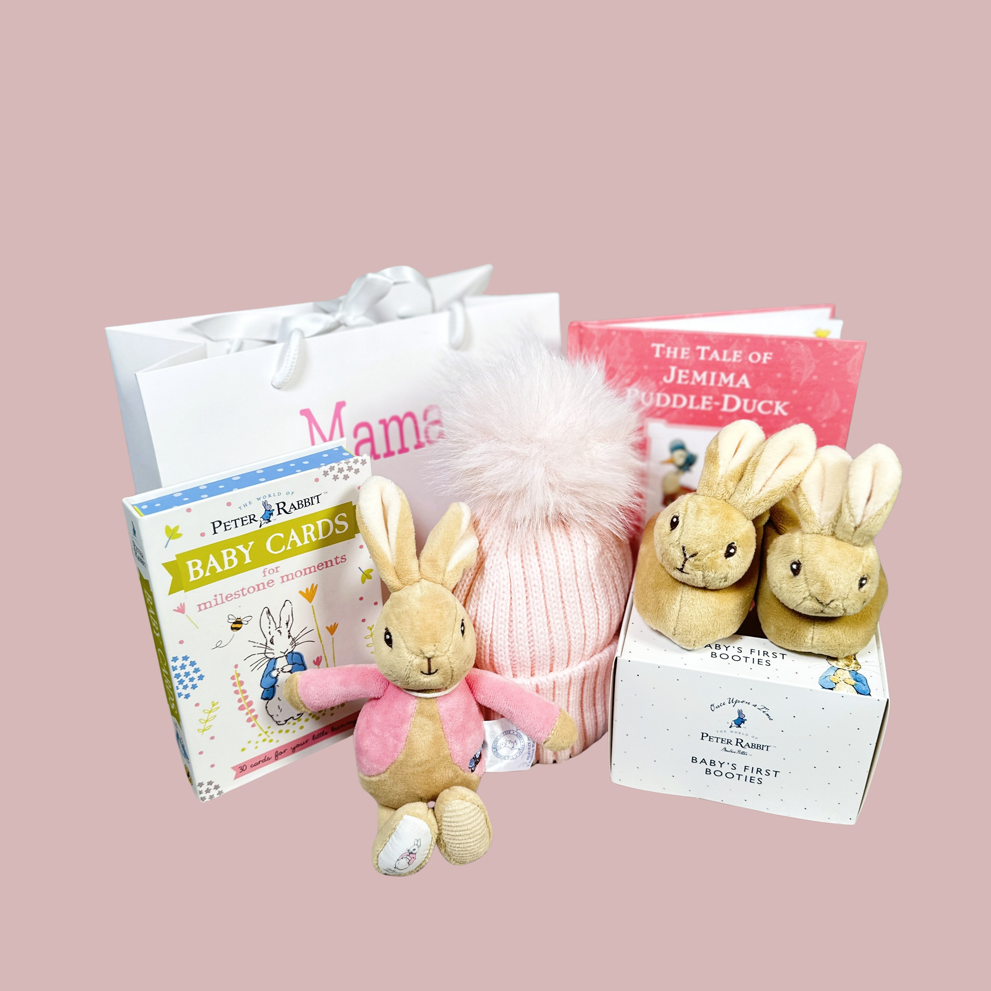 Baby girl hamper with flopsey bunny baby rattle, bunny slippers, pink pompom hat and Peter Rabiit baby milestone cards