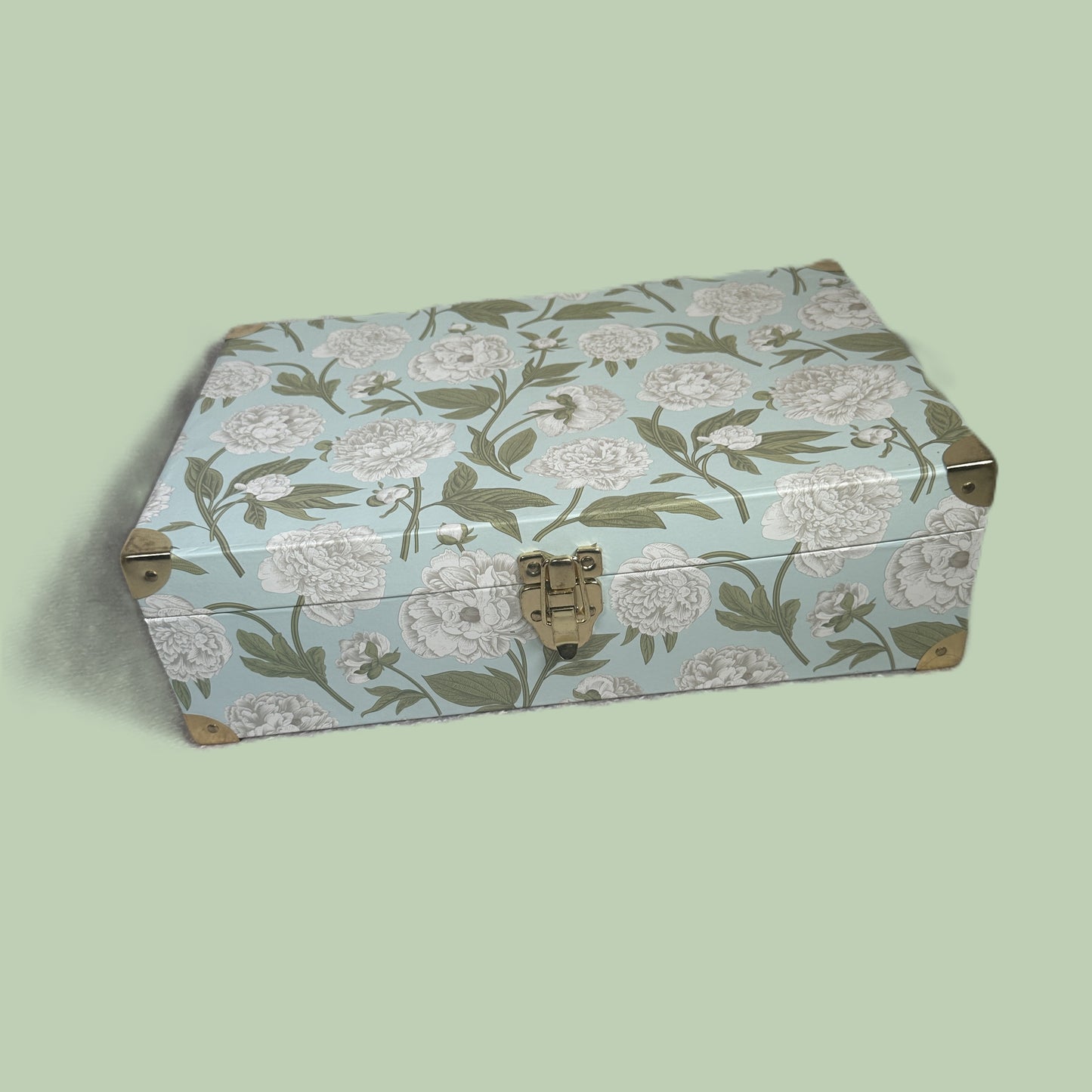 Floral-patterned baby keepsake box on a light green background