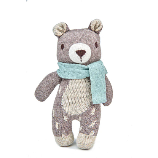 Knitted Fred the bear with a blue scarf on a white background