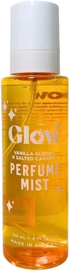 A bottle of Glow Vanilla Almond & Salted Caramel Perfume Mist, featuring a white spray cap and a clear bottle showing the golden-yellow liquid inside, set against a plain white background.