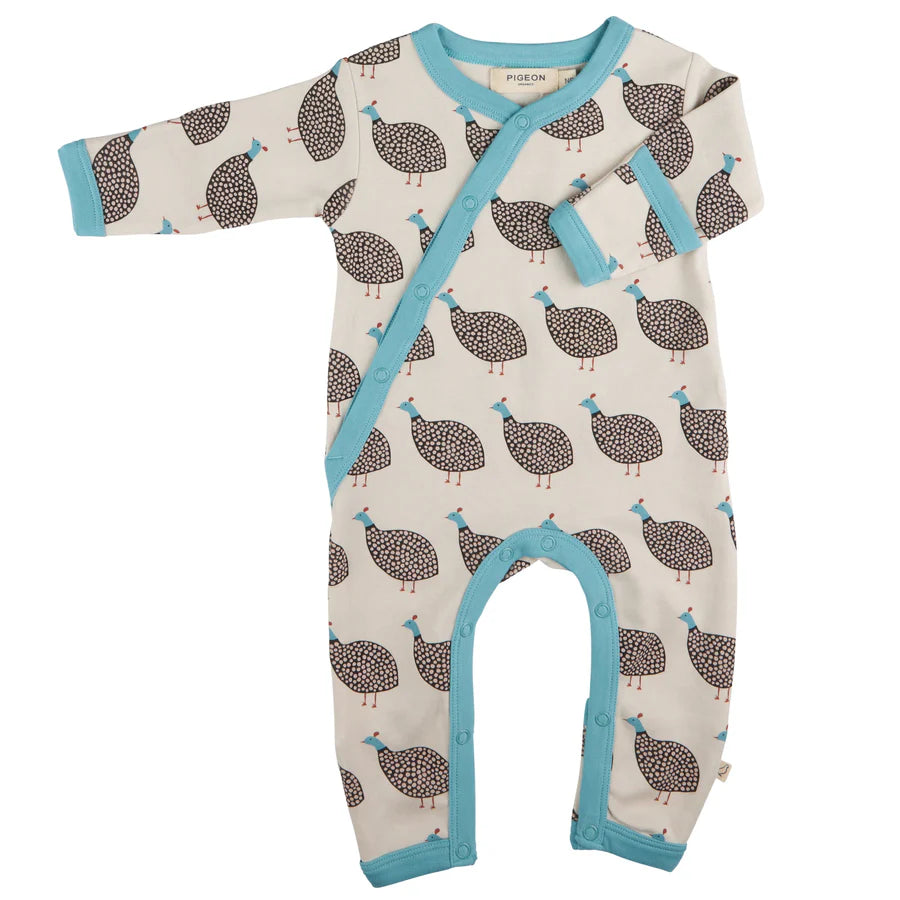 Guinea fowl print organic baby romper with fold over cuffs and feet.