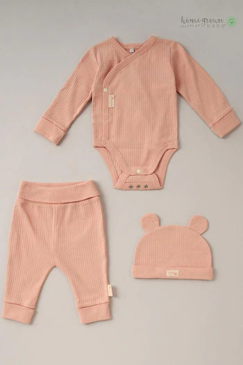 Peach organic cotton baby outfit includes a long sleeved baby bodysuit, baby trousers and a baby hat.