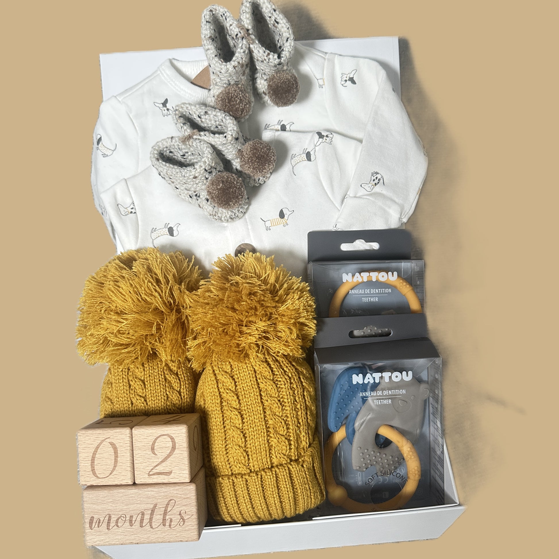 Twin baby hamper gift with baby wear, baby booties and baby teethers.