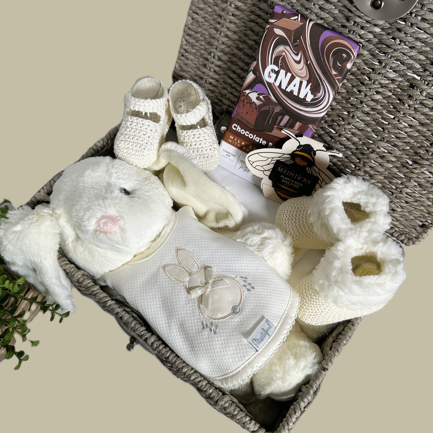 Neutral new baby hamper in white and ivory with baby bai and baby burp cloth