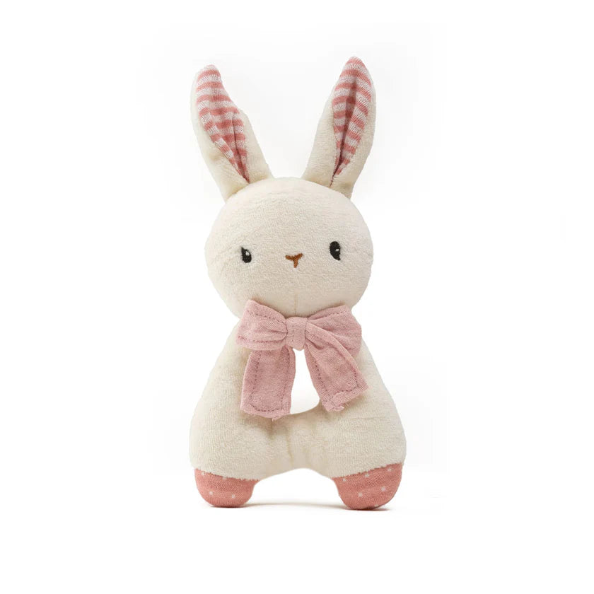 Stuffed rabbit baby rattle with a pink bow on a white background
