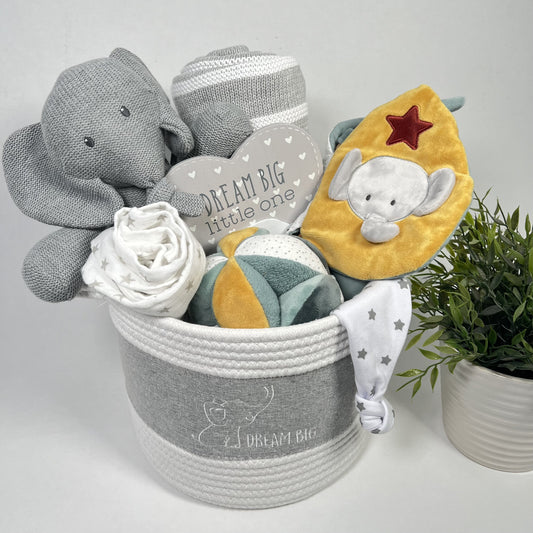 Luxury unisex new baby gift in a "Dream big" caddy containing a \Nattou Tambo elephant soft toy, a Luna and Axel sensort baby activity book made of sensory fabrics, a Nattou activity ball, a grey and white striped cotton baby blanket and a muslin in white with small grey stars and a a matching knotted baby hat.