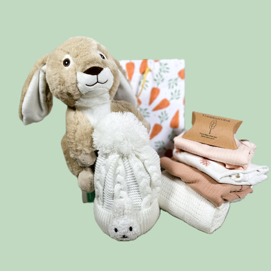 baby girl hamper with plush bunny toy, baby blankets and baby clothes