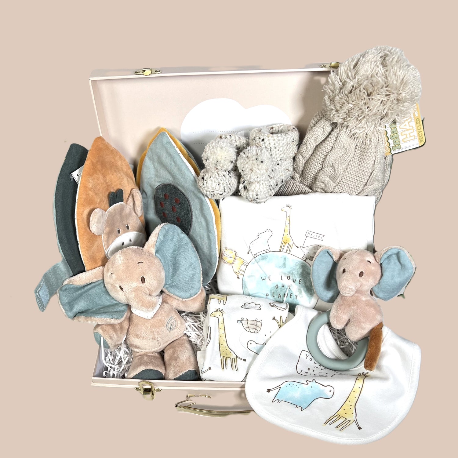 Luxury unisex new parents hamper gift containg a white Hippychick Cellular cotton baby balnlet, an organic cotton layette set "We love our planet", a pair of chrocheted baby booties with pom poms and a Nattou sensory fabric baby book.