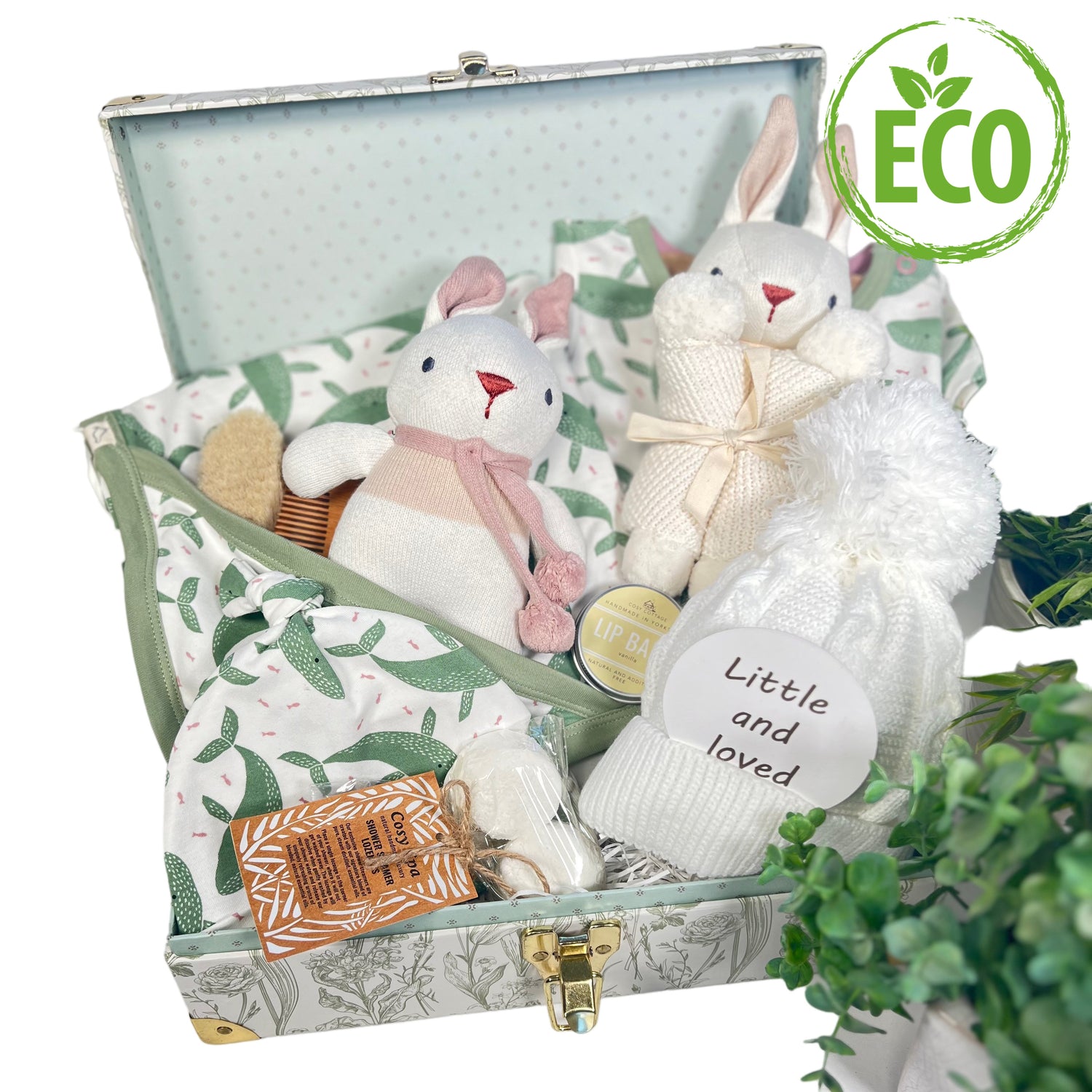 This new baby girl gift comes in a floral baby keepsake case which contains a GOTS certified organic baby blanket, baby body suit and matching baby knot hat, a baby pompom hat and Organic soft baby toys and natural toiletries for the new mummy.