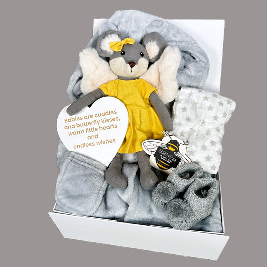 Gift set baby hamper with plush toy, blanket, and baby booties in a white baby keepsake box on a grey background