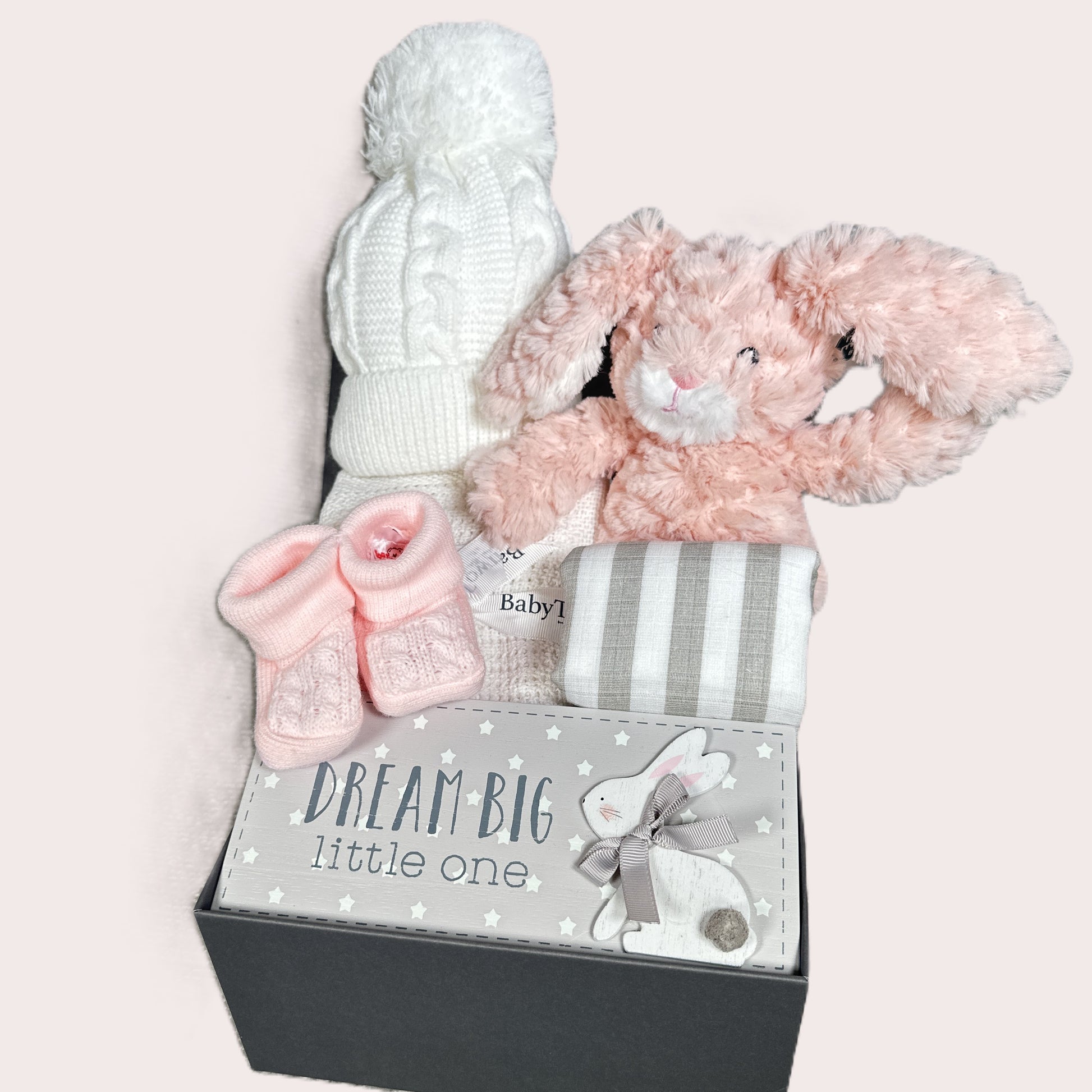 Baby gift set with pink bunny soft baby toy, pink booties, and knitted hat in a baby keepsake box with 'Dream Big Little One' text.
