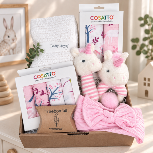 pink baby girl hamper with unicorn print muslins and baby washcloth and unicorn baby rattles