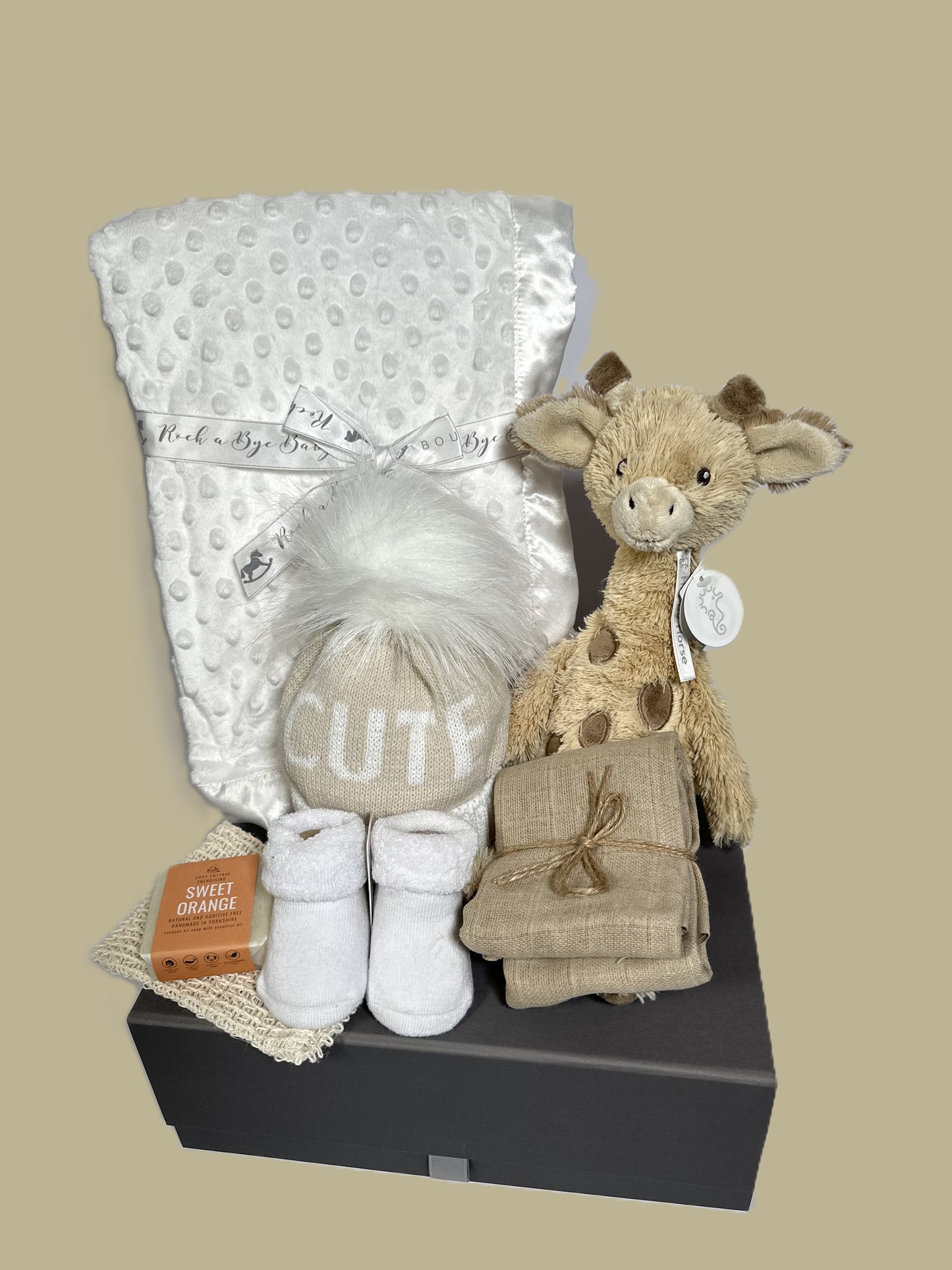 Gus the giraffe baby hamper with white baby blanket and "cute" baby pompom hat.