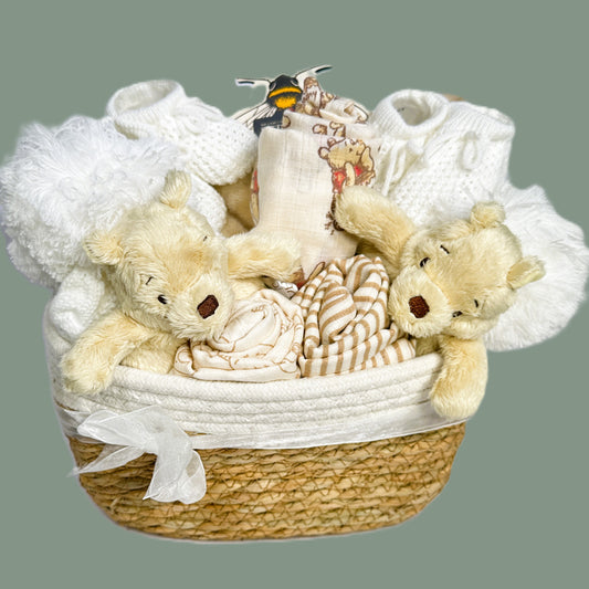 A baby hamper for twins with a Winnie-the-Pooh theme.