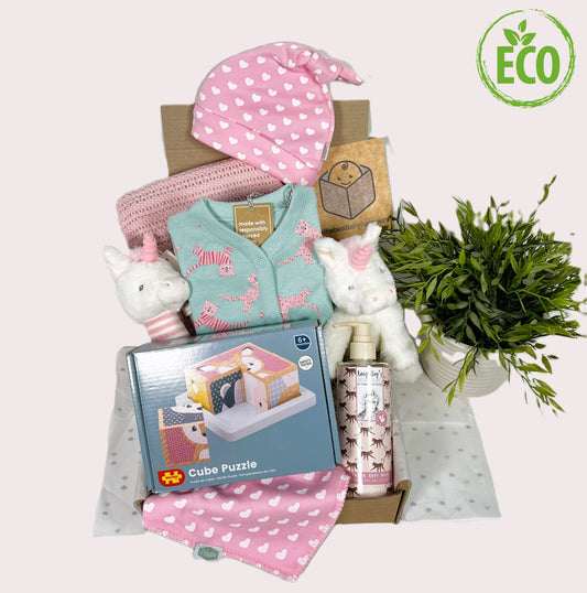 Eco Freindly new baby girl gift hamper containing a 100% cotton cellular soft baby blanket, A sleepsite in miny with a funny kitty patteren. A Ziggle baby knot hat and matching cotton baby big. A cube puzzle made fro FSC wood and painted with child friendly paint and a Keeleco Twinkle unicorn soft toy and matching baby rattle made for recycled plastics.