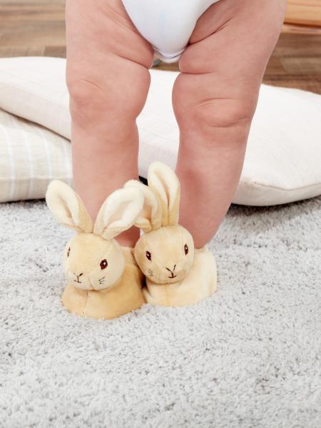 Peter Rabbit first baby booties on a baby