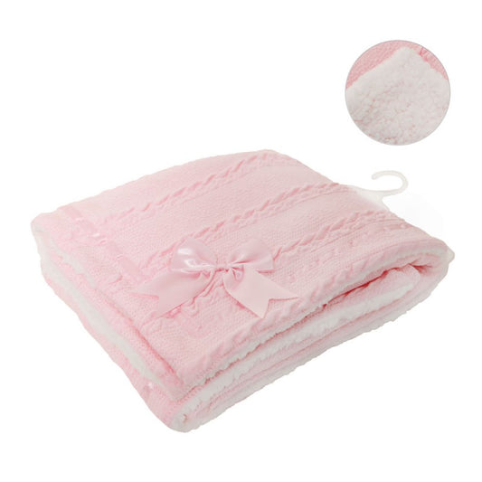 Pink baby blanket with a bow on a white background