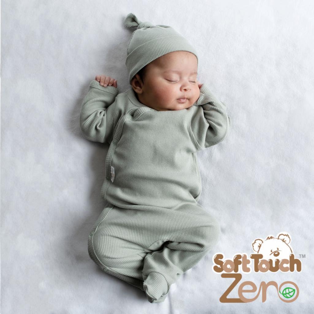 Newborn baby in a green outfit and hat on a white background with 'Soft Touch Zero' branding.