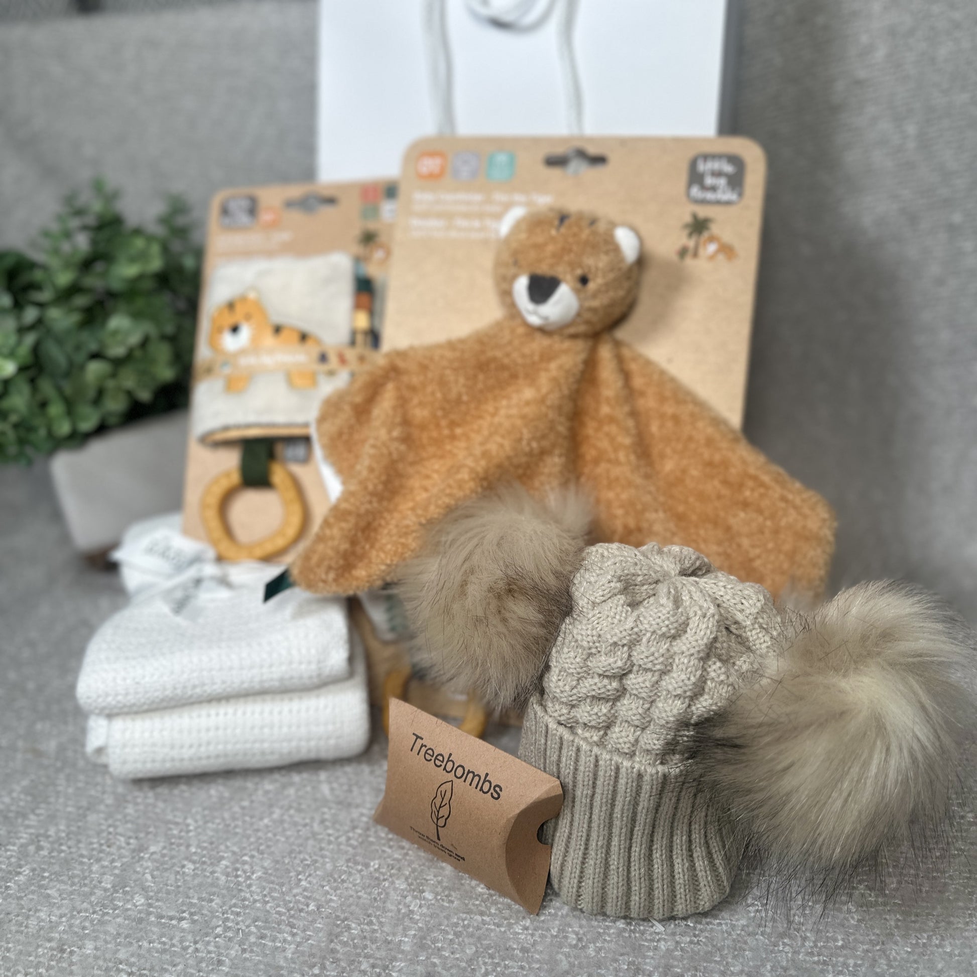 Tiger themed new baby gift with baby comforter, baby book and a baby pompom hat.