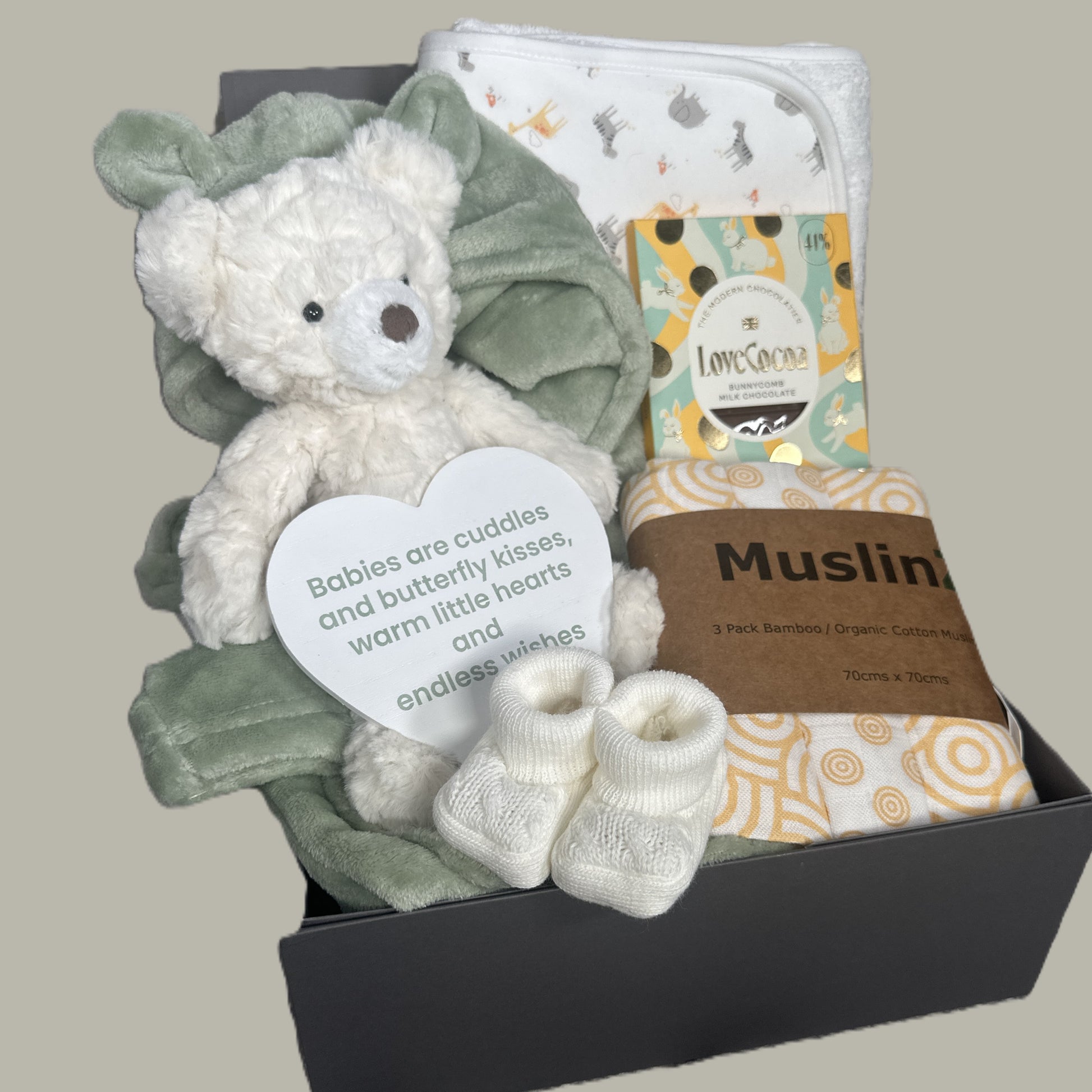 Baby gift set with teddy bear, blanket, and other items in a baby keepsake box.