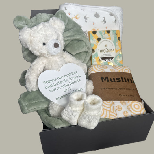 Baby gift set with teddy bear, blanket, and other items in a baby keepsake box.