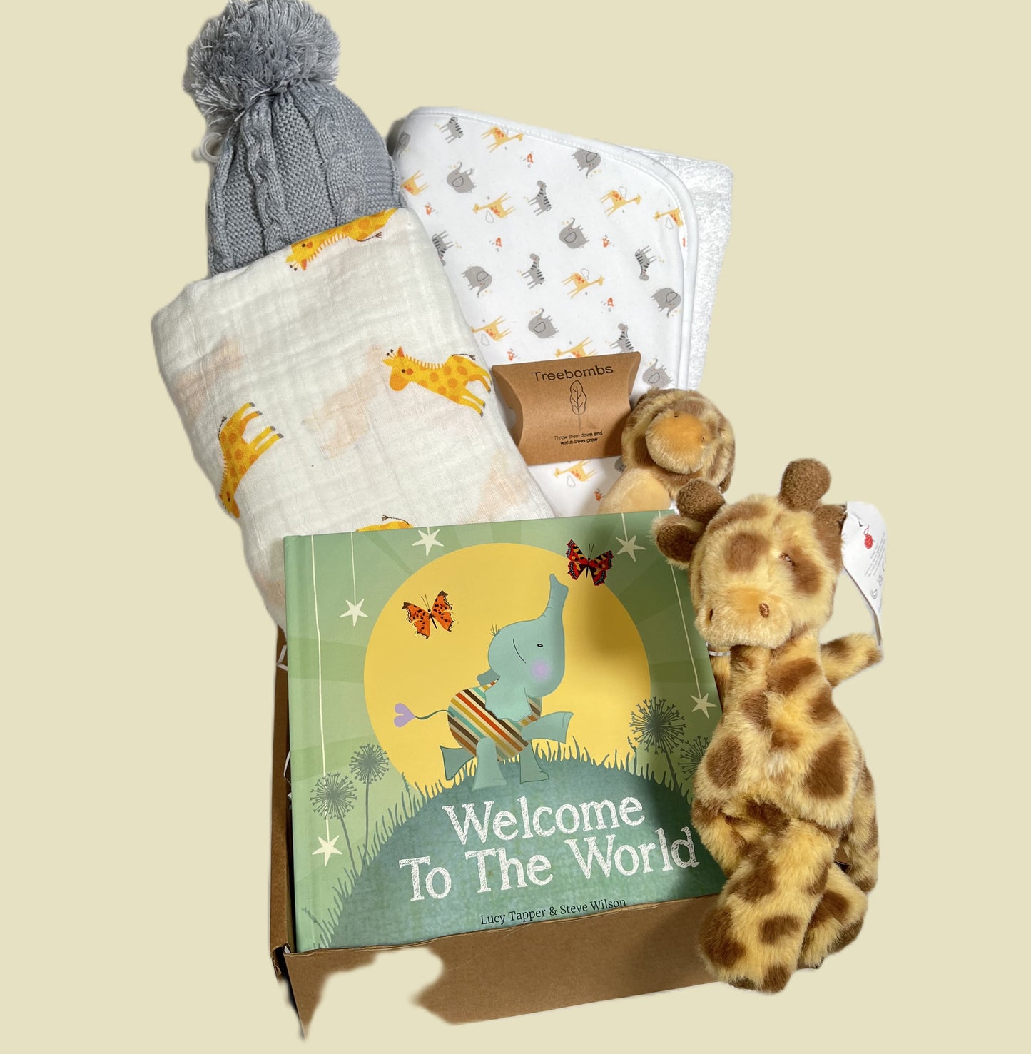 A loveely giraffe themed unisex new mummy and baby hamper with the nicest Lucy taper staory book, a girraffe print large muslin, a cotton hooded baby towel and two \Keeleco giraffe soft baby toys.