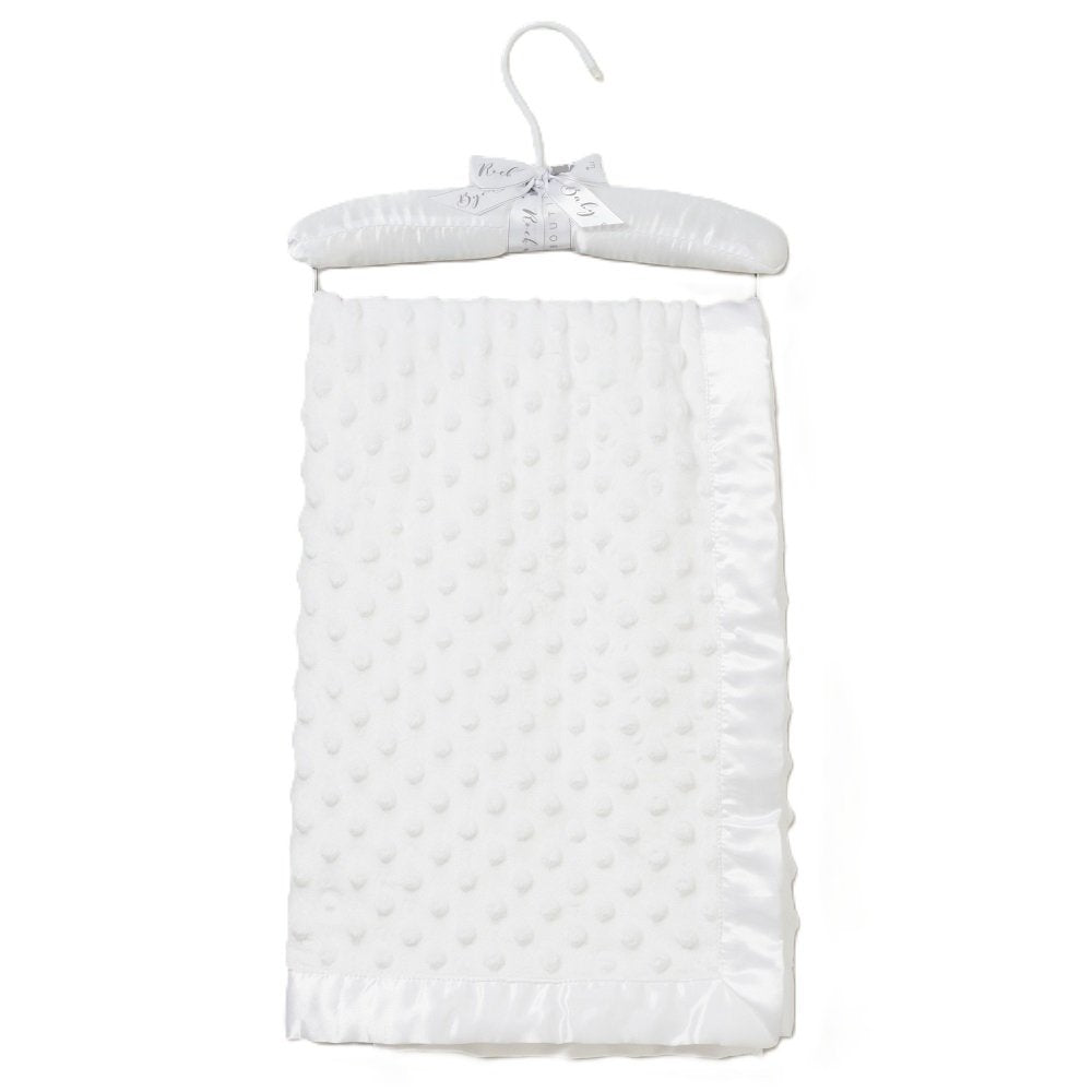 White soft baby blanket  with ribbon tirm on a hanger against a white background